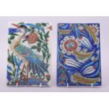 TWO TURKISH IZNIK TILES, one painted with a bird, the other with floral sprays, each approx. 23.