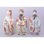 THREE CHINESE PORCELAIN FIGURES, including a figure of Shoulau holding a staff and peach, 24.5cm