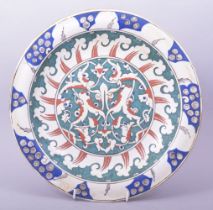 A TURKISH OTTOMAN IZNIK POTTERY DISH, the centre decorated with a roundel containing an interlocking