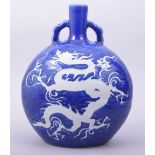 A CHINESE SACRIFICIAL BLUE PORCELAIN TWIN HANDLE MOON FLASK, the body decorated with a white