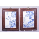 A PAIR OF EARLY 20TH CENTURY FRAMED BLUE AND WHITE PORCELAIN PLAQUES, the panels depicting a