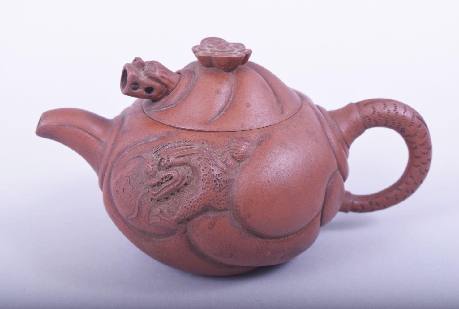 A CHINESE YIXING TEAPOT, the side with moulded dragon and carp, the cover with reticulated dragon