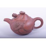 A CHINESE YIXING TEAPOT, the side with moulded dragon and carp, the cover with reticulated dragon