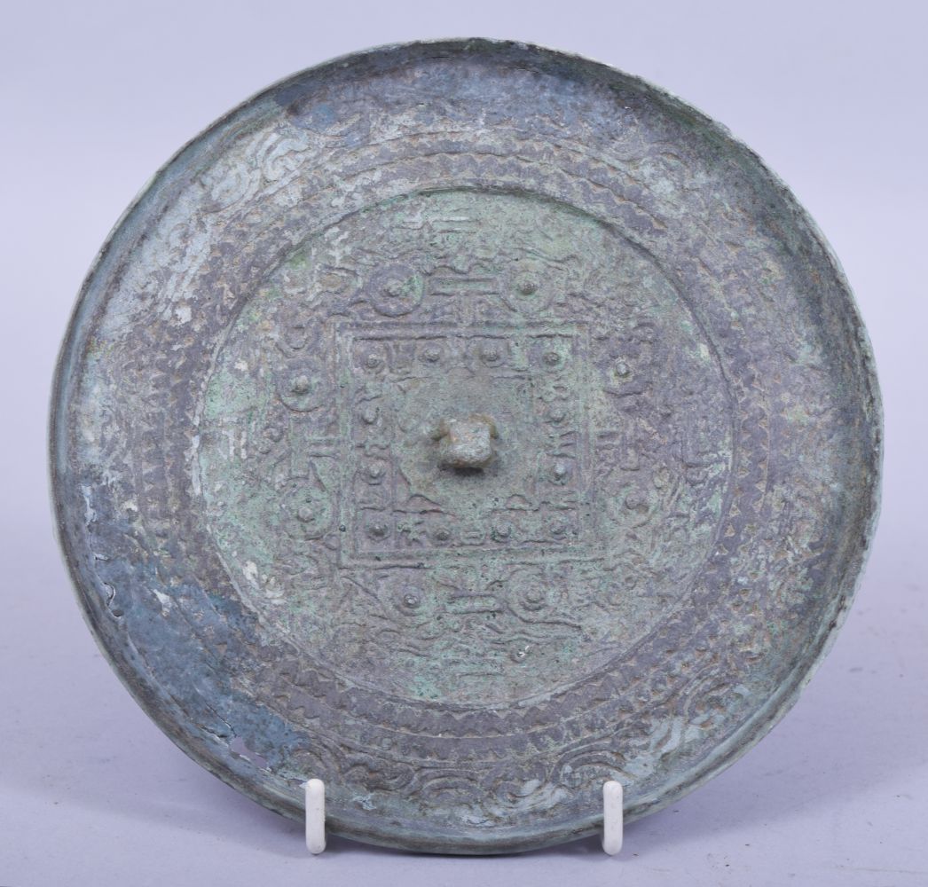 A CHINESE ARCHAIC BRONZE MIRROR, possibly tang dynasty, 15.5cm diameter.