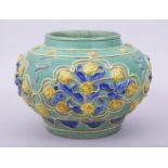 A CHINESE MING STYLE FAHUA JAR, with raised decoration depicting panels of flowers, 17cm high,