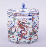 A CHINESE WUCAI PORCELAIN RIBBED CYLINDRICAL BOX AND COVER, the exterior painted with dragon and