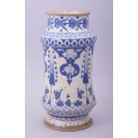 A TURKISH BLUE AND WHITE POTTERY MEDICINE JAR, decorated with floral motifs, 26.5cm high.