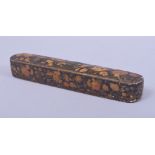 A 19TH CENTURY PERSIAN QAJAR LACQUERED PAPIER MACHE QALAMDAN PEN BOX, with floral decoration, 23.5cm