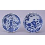 A NEAR PAIR OF CHINESE BLUE AND WHITE PORCELAIN DISHES, both depicting figures in an outdoor