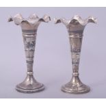 A PAIR OF IRAQI SILVER AND NIELLO FLUTED VASES, each signed, 17.5cm high.