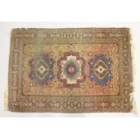 A SMALL PERSIAN RUG, rust ground with three medallions. 4ft x 2ft 8ins.