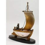 A GOOD PALAIS ROYAL MOTHER OF PEARL SHELL BOAT on a black oval base. 20cm long.