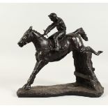 A GOOD BRONZE HORSE AND JOCKEY OVER STICKS. 11ins high.