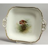 A ROYAL WORCESTER TWO HANDLED DISH painted with a goldfinch, titled, by E. Townsend, signed with