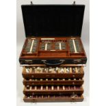 A FOLDING CASE OF EYE TEST LENSES, AND A CHEST OF FOUR DRAWERS FILLED WITH SPECTACLE LENSES.