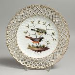 A GOOD MEISSEN PORCELAIN CIRCULAR PLATE with pierced border, the centre painted with birds. Cross