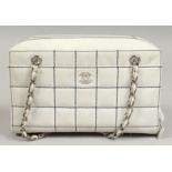 A CREAM PADDED BAG with leather chrome handle. 29cm long.