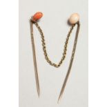TWO GOLD AND CORAL STICK PINS.