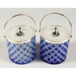 A PAIR OF BLUE GLASS AND CUT GLASS CIRCULAR BISCUIT BARRELS with plated lids and handles.
