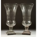 A GOOD PAIR OF CUT GLASS THISTLE-SHAPED VASES on stepped square bases. 17ins high.