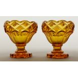 A PAIR OF BOHEMIAN AMBER GLASS PEDESTAL SALTS