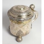A LARGE SWEDISH SILVER TANKARD the top inset with a medallion, bell knop and three ball feet. Weighs