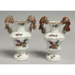 A PAIR OF 18TH CENTURY BUEN RETIRO PAINTED VASES with dolphin handles painted with flowers on each