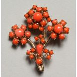 A CORAL FLOWER BROOCH.