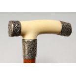 A VICTORIAN IVORY AND SILVER HANDLED WALKING STICK. Birmingham 1886. 34ins long.