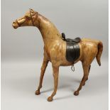 A GOOD LARGE LEATHER HORSE, POSSIBLY LIBERTY, with leather saddle. 27ins high.