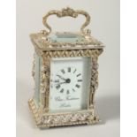 A CHARLES FRODSHAM SILVER CASED MINIATURE CLOCK, the case with caryatid figures, carrying handles on