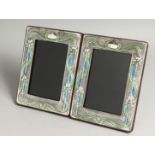 A PAIR OF SILVER AND BLUE ENAMEL PHOTOGRAPH FRAMES. 7.5ins x 5.5ins.