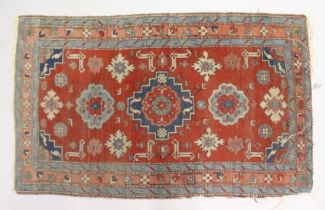A SMALL PERSIAN RUG, red ground with geometric decoration. 4ft 2ins x 2ft 7ins