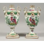 A PAIR OF SAMSON PORCELAIN TWO HANDLED URN SHAPED VASES painted with birds, on square legs. 9.5ins