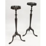 A PAIR OF GEORGE III STYLE MAHOGANY TORCHERES the octagonal tops with pierced galleries on turned