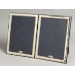 A LARGE PAIR OF SILVER PHOTOGRAPH FRAMES. 19cm x 14cm.