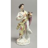 AN 18TH CENTURY MEISSEN FIGURE OF A FEMALE ARTIST with paint brushes and artist palette, wearing a