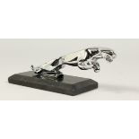 A JAGUAR CHROME CAR MASCOT. 7ins long on a marble base.