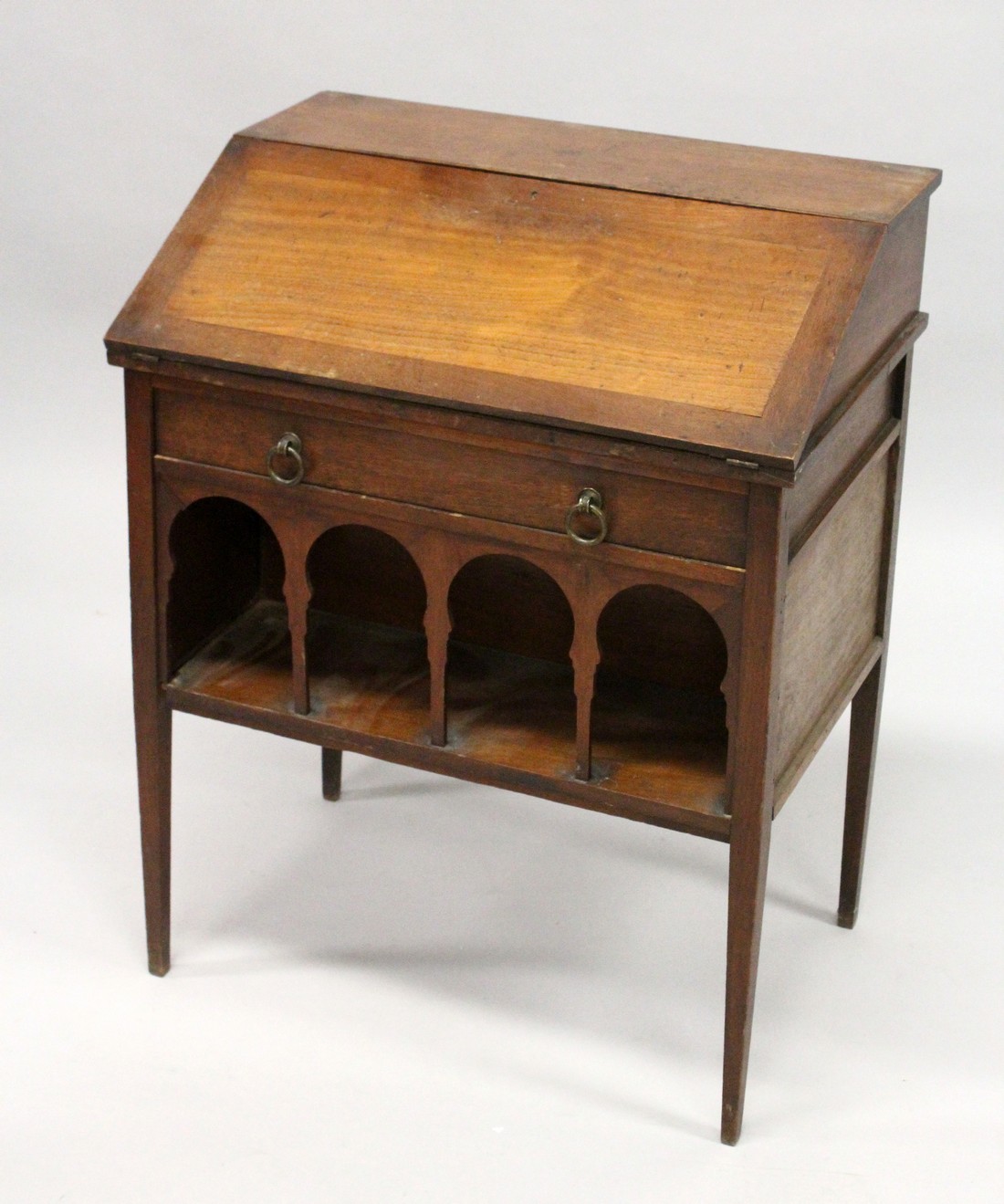 LIBERTY & CO. A SMALL ARTS AND CRAFTS WALNUT BUREAU, the fall front enclosing pigeon holes and a