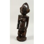 A GOOD CARVED WOOD YORUBO FEMALE STANDING FIGURE. 18ins.