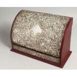 A SILVER EMBOSSED STATIONARY BOX, opening to reveal a fitted interior. Maker, M & LS 11ins wide.
