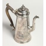 A GEORGE II TAPERING COFFEE POT AND COVER with cast spout and wooden handles. 8.25ins high with