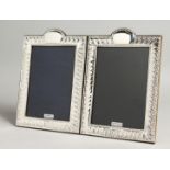 A LARGE PAIR OF SILVER PHOTOGRAPH FRAMES. 19cm x 14cm