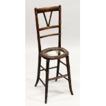 A 19TH CENTURY BEECH FRAMED AND CANE WORK SEATED CORRECTION CHAIR (SEAT A. F.). 3ft 2ins high