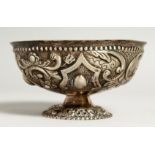 A CONTINENTAL SILVER EMBOSSED CIRCULAR PEDESTAL BOWL.