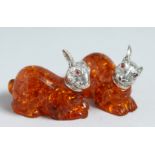 A PAIR OF FAUX AMBER RABBITS