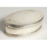 AN OVAL SILVER BOX with blue velvet liner, 4.75ins. London, 1912.