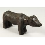 A RARE NAIVE LIGNUM VITAE PIG 7.5ins long.