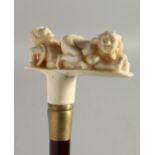 A WALKING STICK with carved bone handle 'Erotic'. 36ins long.