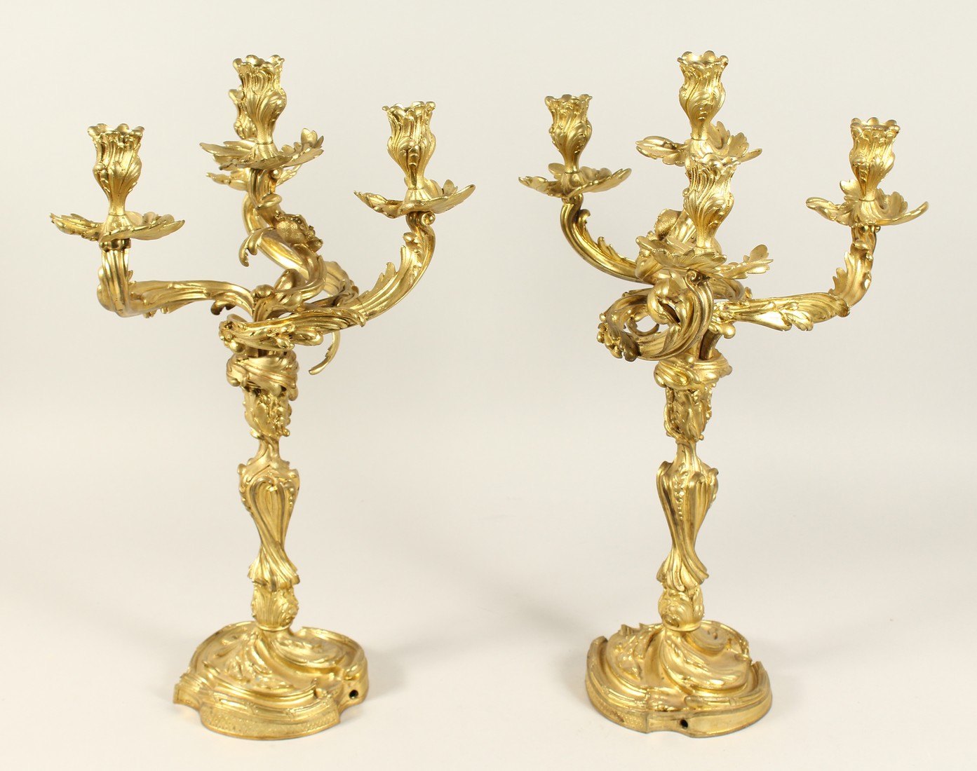 A GOOD PAIR OF ROCOCCO ORMOLU FOUR LIGHT CANDELABRA, with four naturalistic scrolling branches on